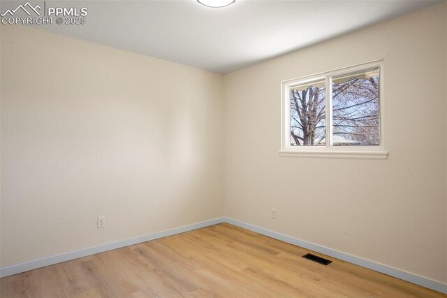 2118 S El Paso Ave, Colorado Springs, CO 80905 - empty room with visible vents, baseboards, and wood finished floors