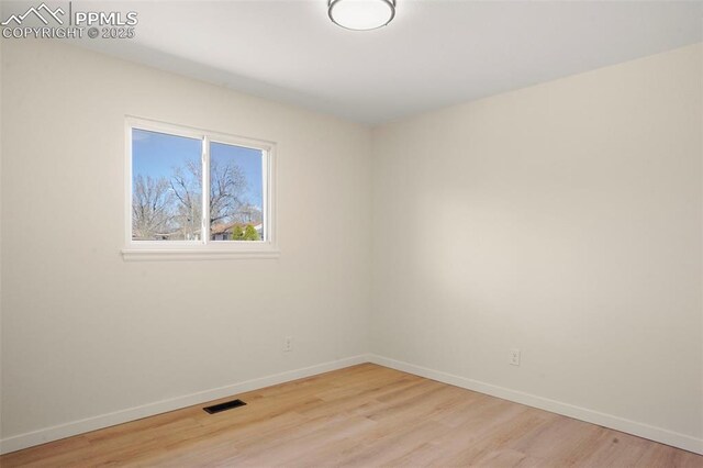 2118 S El Paso Ave, Colorado Springs, CO 80905 - unfurnished room featuring baseboards, visible vents, and light wood-style flooring