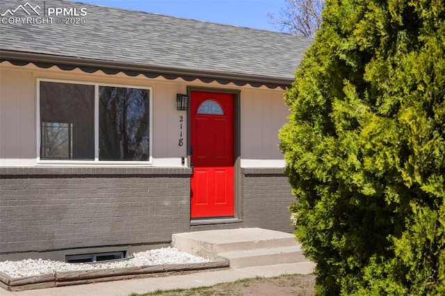 2118 S El Paso Ave, Colorado Springs, CO 80905 - view of exterior entry with brick siding and roof with shingles