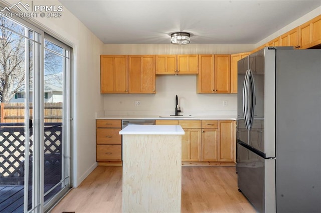 2118 S El Paso Ave, Colorado Springs, CO 80905 - kitchen featuring a sink, a kitchen island, freestanding refrigerator, light brown cabinets, and light wood-style floors