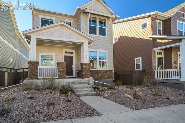 1341 Solitaire St, Colorado Springs, CO 80905 - craftsman house with fence, stone siding, and a porch