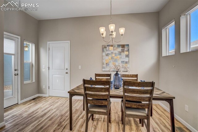 1341 Solitaire St, Colorado Springs, CO 80905 - dining area featuring baseboards, a wealth of natural light, wood finished floors, and a chandelier
