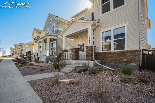 1341 Solitaire St, Colorado Springs, CO 80905 - view of home's exterior with a residential view, stone siding, and a porch