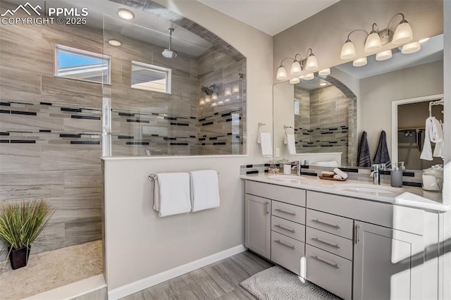1341 Solitaire St, Colorado Springs, CO 80905 - full bath with double vanity, wood finished floors, a walk in shower, and a sink