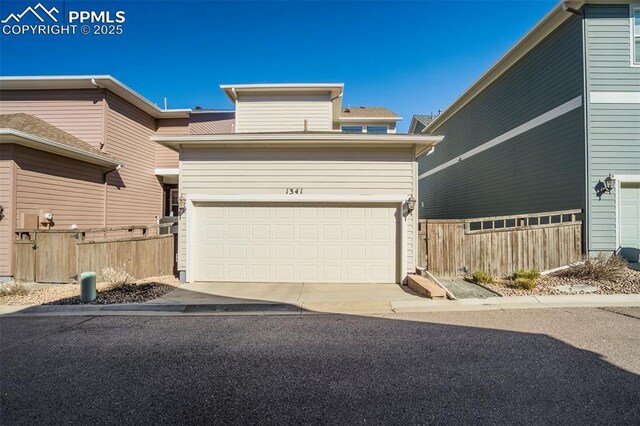 1341 Solitaire St, Colorado Springs, CO 80905 - view of front of home featuring a garage and fence