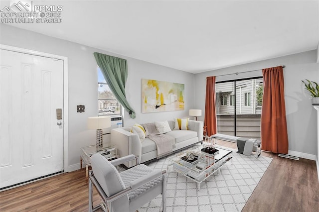 living area featuring wood finished floors and baseboards