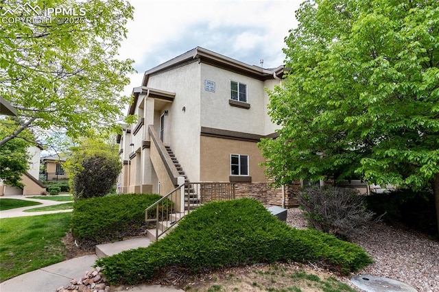 3815 Riviera Grv Unit 201, Colorado Springs, CO 80922 - view of front of house with stucco siding and stairway