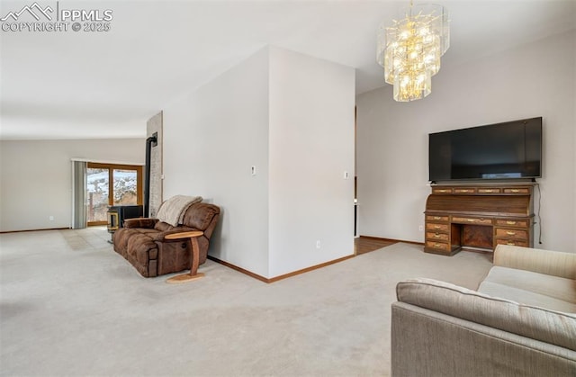 5865 Waterfall Loop, Manitou Springs, CO 80829 - carpeted living room featuring baseboards, a wood stove, and a notable chandelier
