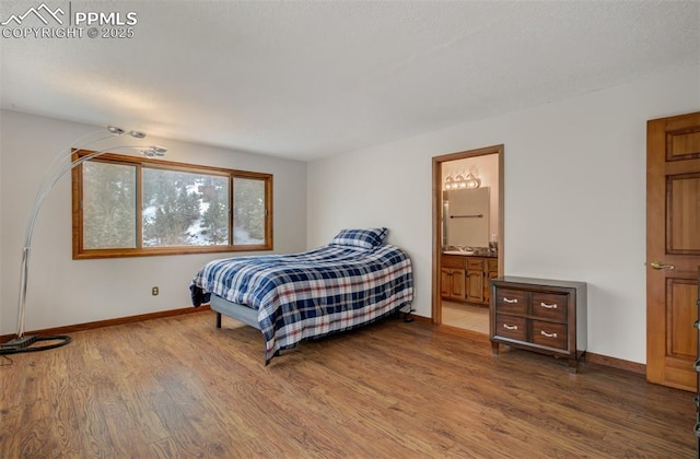5865 Waterfall Loop, Manitou Springs, CO 80829 - bedroom with ensuite bathroom, baseboards, and wood finished floors