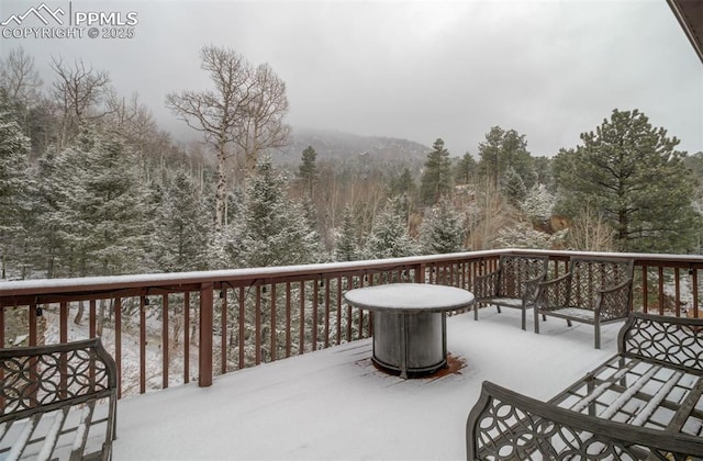 5865 Waterfall Loop, Manitou Springs, CO 80829 - snow covered deck featuring a view of trees