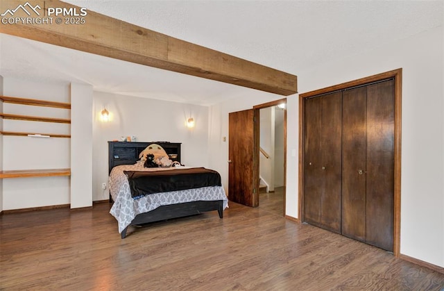 5865 Waterfall Loop, Manitou Springs, CO 80829 - bedroom with beam ceiling, baseboards, and wood finished floors