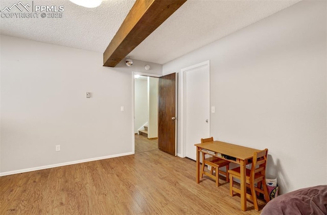 5865 Waterfall Loop, Manitou Springs, CO 80829 - interior space with stairs, baseboards, a textured ceiling, beam ceiling, and light wood-style flooring