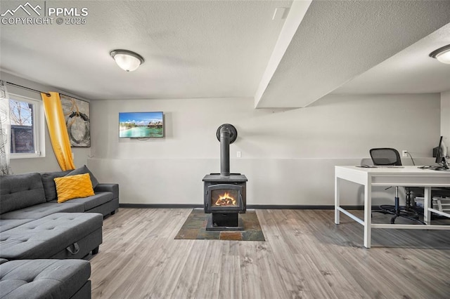 2219 Sonoma Dr, Colorado Springs, CO 80910 - living area with baseboards, a textured ceiling, wood finished floors, and a wood stove