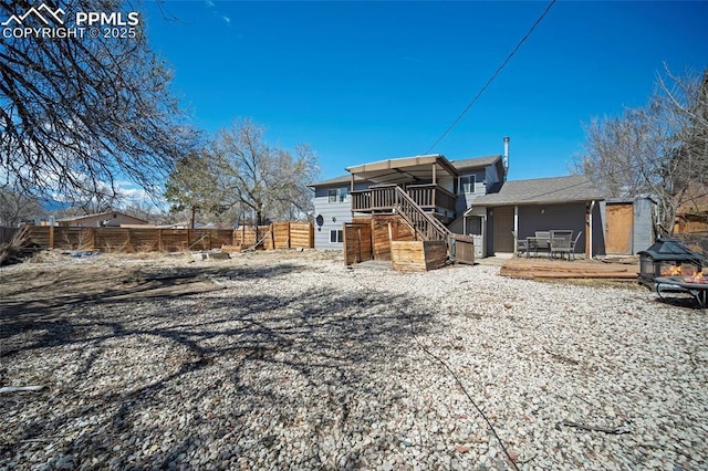 2219 Sonoma Dr, Colorado Springs, CO 80910 - back of property with fence, stairway, and a deck