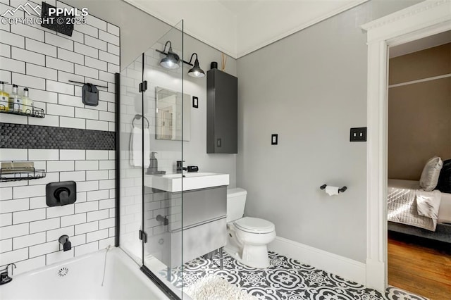 ensuite bathroom featuring ensuite bath, tile patterned flooring, toilet, baseboards, and bath / shower combo with glass door