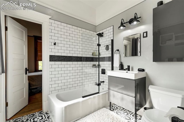 bathroom with washtub / shower combination, wood finished floors, vanity, and toilet