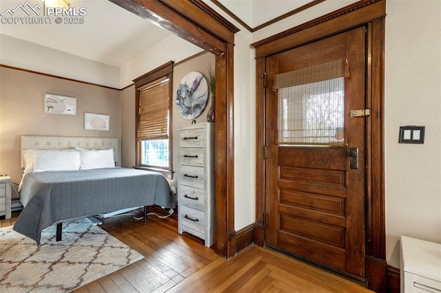 bedroom featuring wood finished floors and baseboards