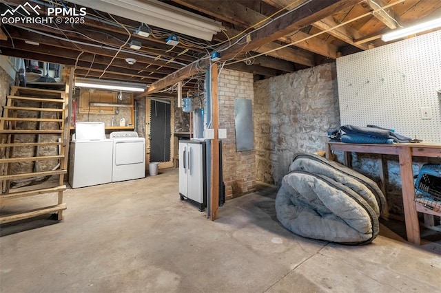 unfinished below grade area with a workshop area and washer and dryer