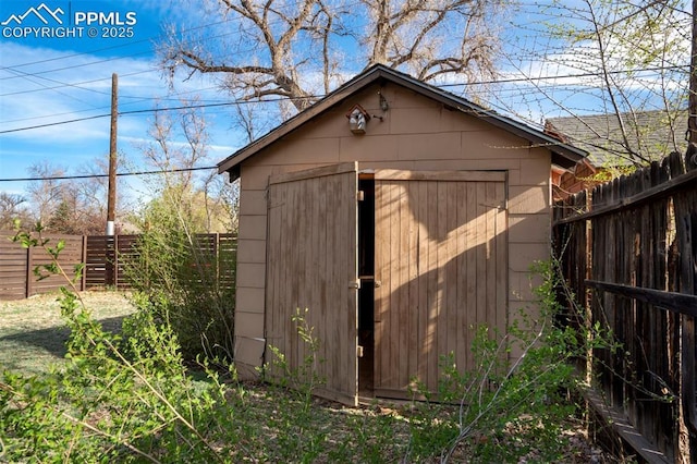 view of shed with a fenced backyard