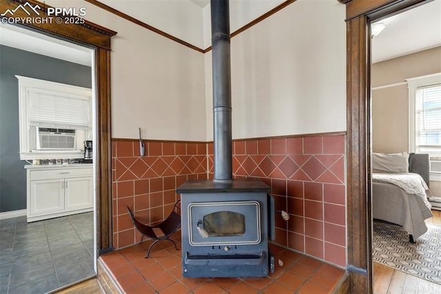 room details with cooling unit, a wood stove, and wainscoting