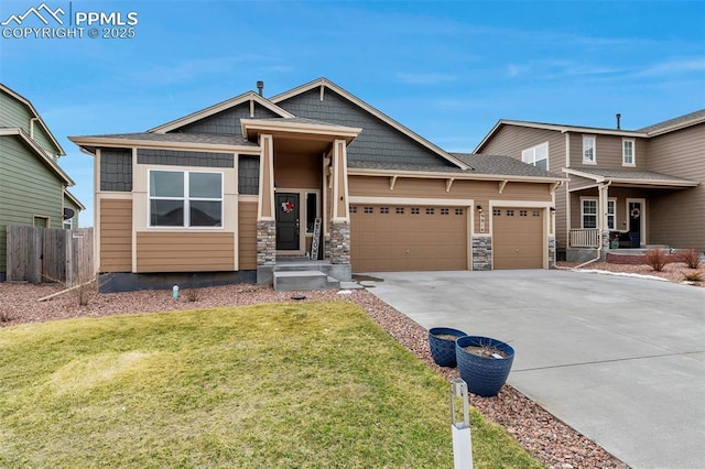 craftsman-style home with fence, driveway, stone siding, and a garage