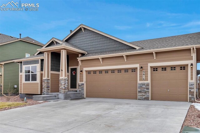 craftsman-style home with driveway, stone siding, a garage, and roof with shingles