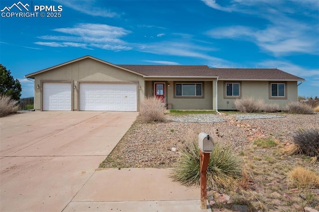 single story home with stucco siding, driveway, and a garage
