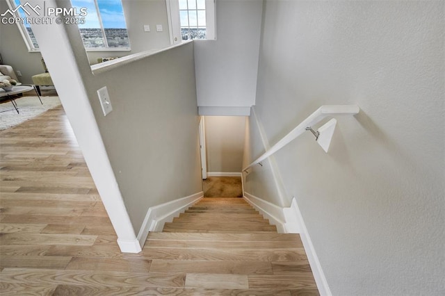 stairs with baseboards and wood finished floors