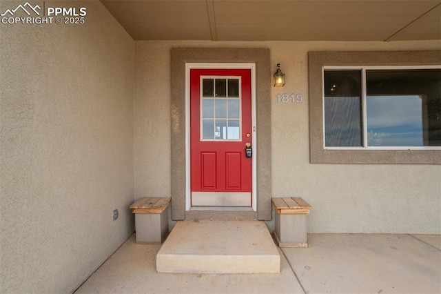 doorway to property with stucco siding