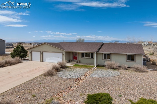 ranch-style house featuring stucco siding, driveway, a shingled roof, and a garage