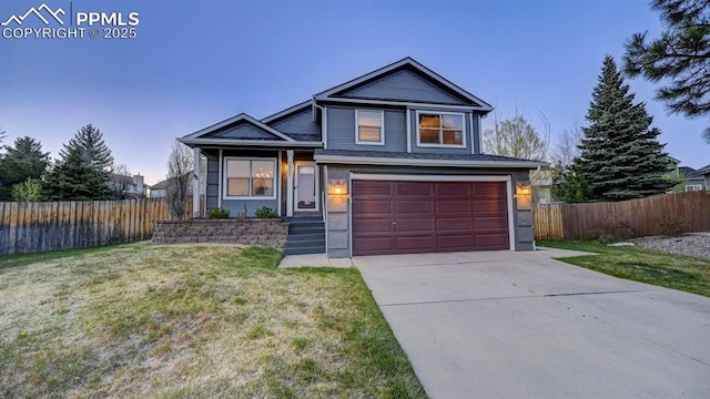 view of front facade with fence, concrete driveway, a front lawn, and a garage