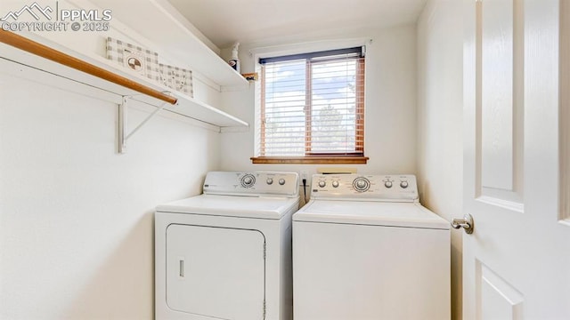 clothes washing area featuring washer and dryer and laundry area