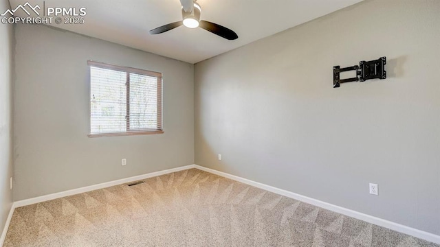 carpeted empty room featuring visible vents, baseboards, and ceiling fan