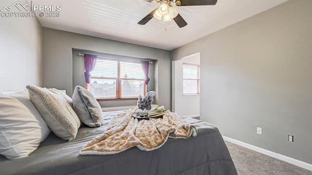carpeted bedroom featuring baseboards and a ceiling fan