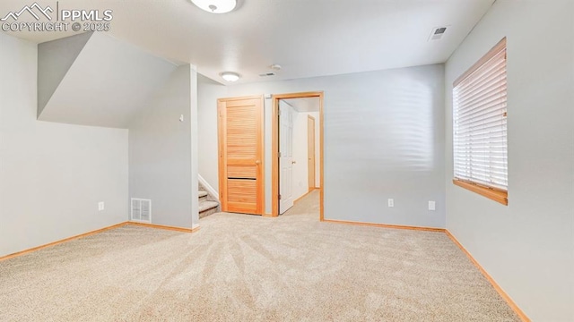 unfurnished bedroom featuring baseboards, a closet, visible vents, and carpet
