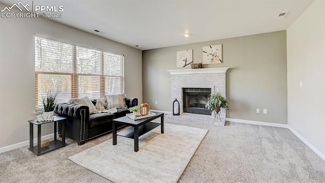 living room featuring carpet, baseboards, visible vents, and a fireplace