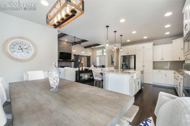 16224 Sunrise Glory Ln, Monument, CO 80132 - dining space with ceiling fan with notable chandelier, dark wood-style flooring, beamed ceiling, and recessed lighting