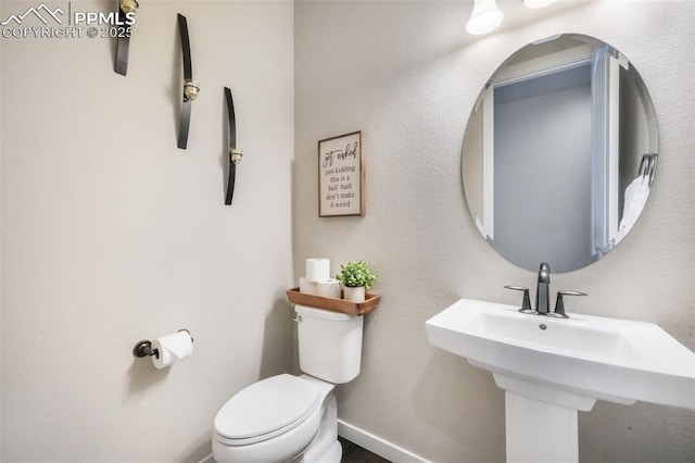 16224 Sunrise Glory Ln, Monument, CO 80132 - half bath featuring baseboards, a sink, and toilet