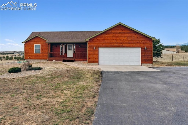 13255 Woodlake Rd, Elbert, CO 80106 - view of front facade with aphalt driveway and a garage