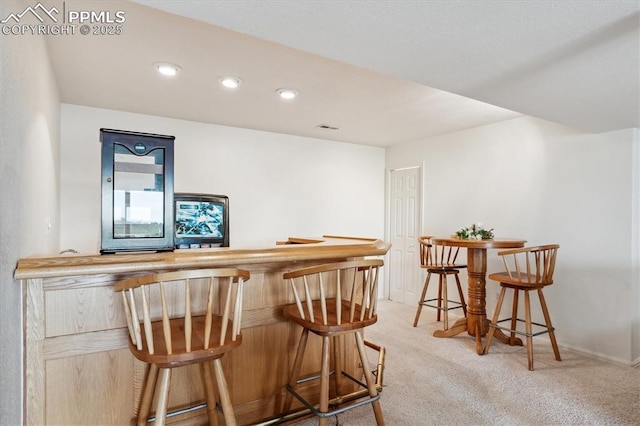 13255 Woodlake Rd, Elbert, CO 80106 - bar with a bar, recessed lighting, baseboards, carpet flooring, and visible vents