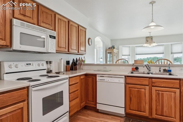 13255 Woodlake Rd, Elbert, CO 80106 - kitchen featuring a sink, white appliances, brown cabinets, light wood-type flooring, and light countertops