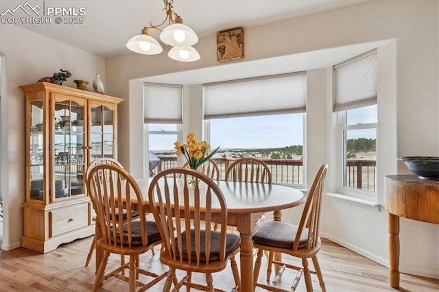 13255 Woodlake Rd, Elbert, CO 80106 - dining space with a chandelier, light wood-style flooring, and baseboards