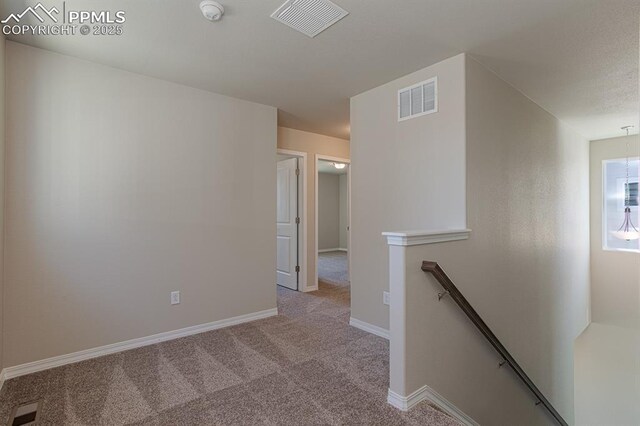 5229 Devers Ct, Colorado Springs, CO 80925 - corridor featuring baseboards, an upstairs landing, visible vents, and carpet