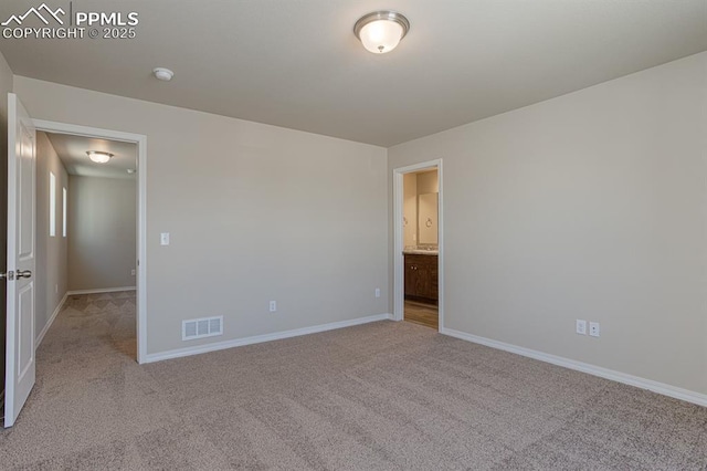 5229 Devers Ct, Colorado Springs, CO 80925 - unfurnished bedroom with connected bathroom, baseboards, visible vents, and carpet flooring