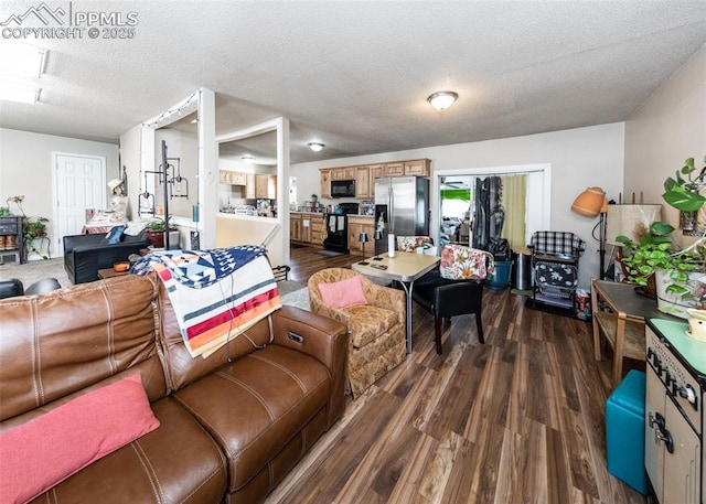 2914 Del Mar Cir, Colorado Springs, CO 80910 - living area with dark wood-style flooring and a textured ceiling