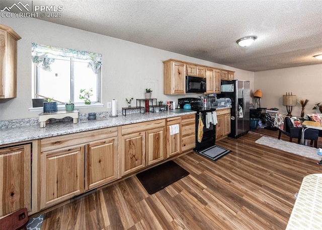 2914 Del Mar Cir, Colorado Springs, CO 80910 - kitchen featuring black appliances, dark wood-style floors, a textured ceiling, and light stone counters