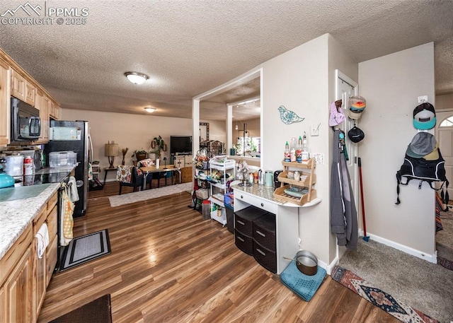 2914 Del Mar Cir, Colorado Springs, CO 80910 - kitchen with black microwave, stainless steel electric stove, light countertops, light wood-style flooring, and a textured ceiling