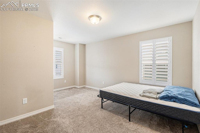 carpeted bedroom with baseboards