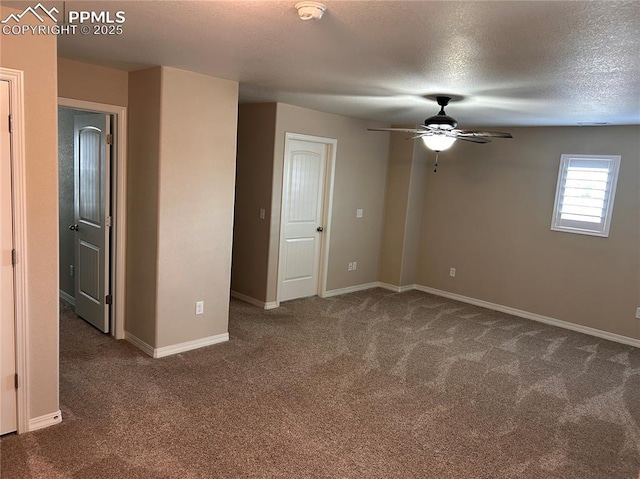carpeted spare room with a ceiling fan, a textured ceiling, and baseboards