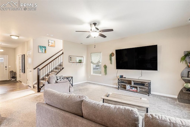 living room featuring carpet flooring, stairway, ceiling fan, and baseboards